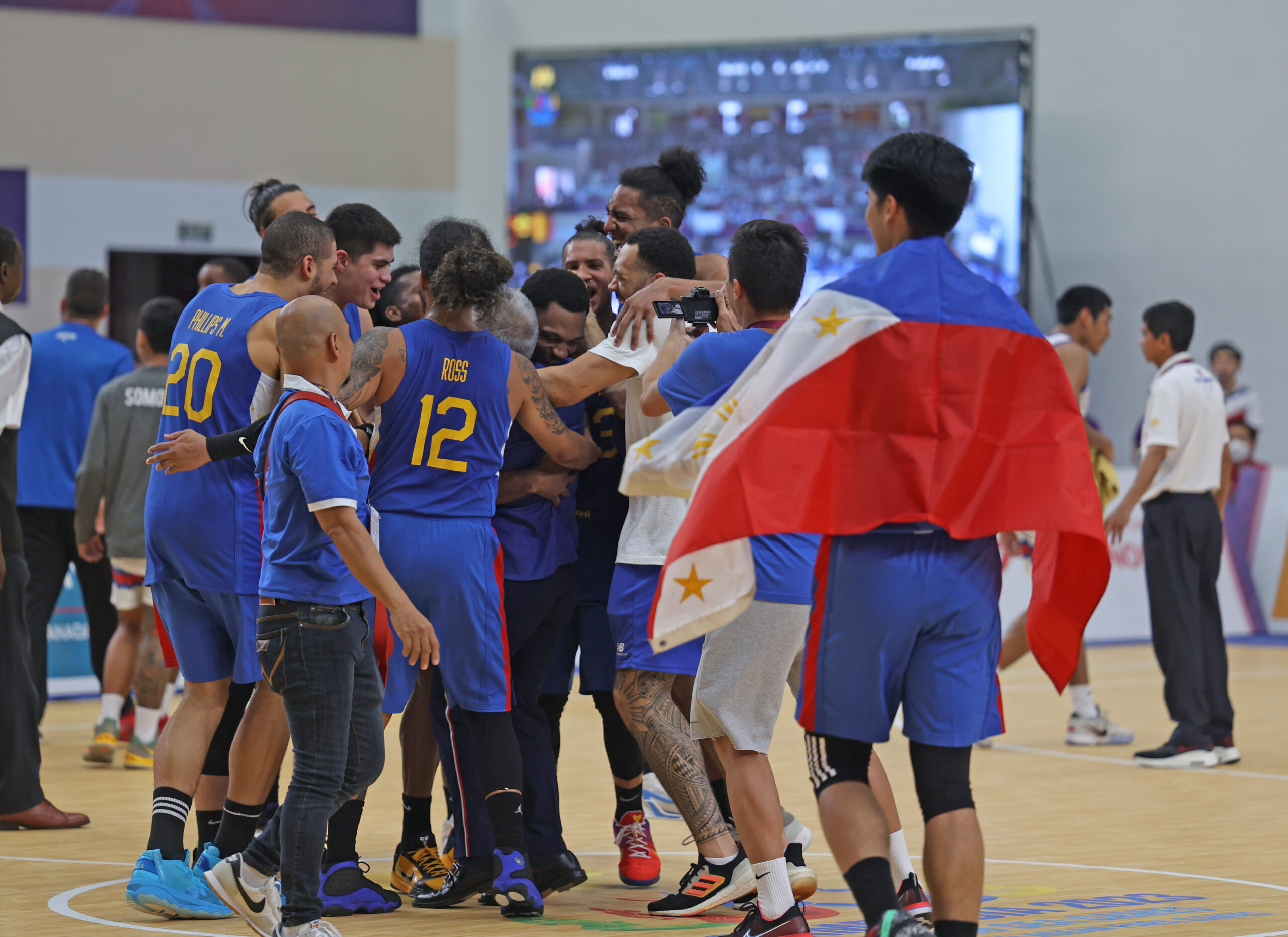 Gilas Pilipinas players lift head coach Chot Reyes to celebrate the SEA Games 2023 men's basketball gold. –TEAM PHILIPPINES POOL
