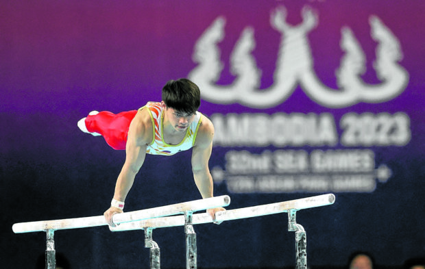A strong performance on the parallel bars greased Carlos Yulo’s path to the all-around gold. —PHOTOS FROM REUTERS