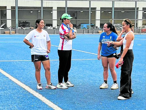 Bea Tan (right) and other members of the Makati Football Club discuss last-minute preparations for Saturday’s opening.  —INQUIRER PHOTO