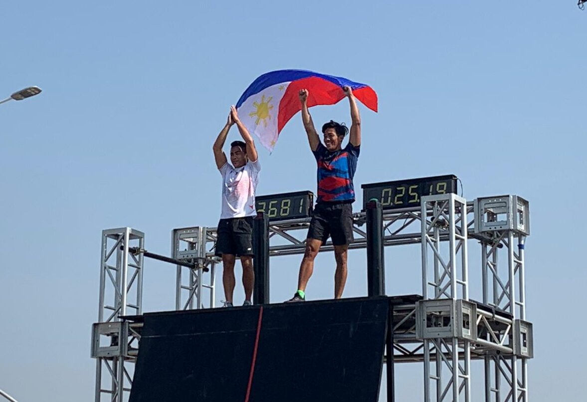 Mark Julius Rodelas (right) and Kevin Pascua raise the flag after winning the gold and silver medals, respectively, in the men's obstacle race at the SEA Games 2023. –JUNE NAVARRO