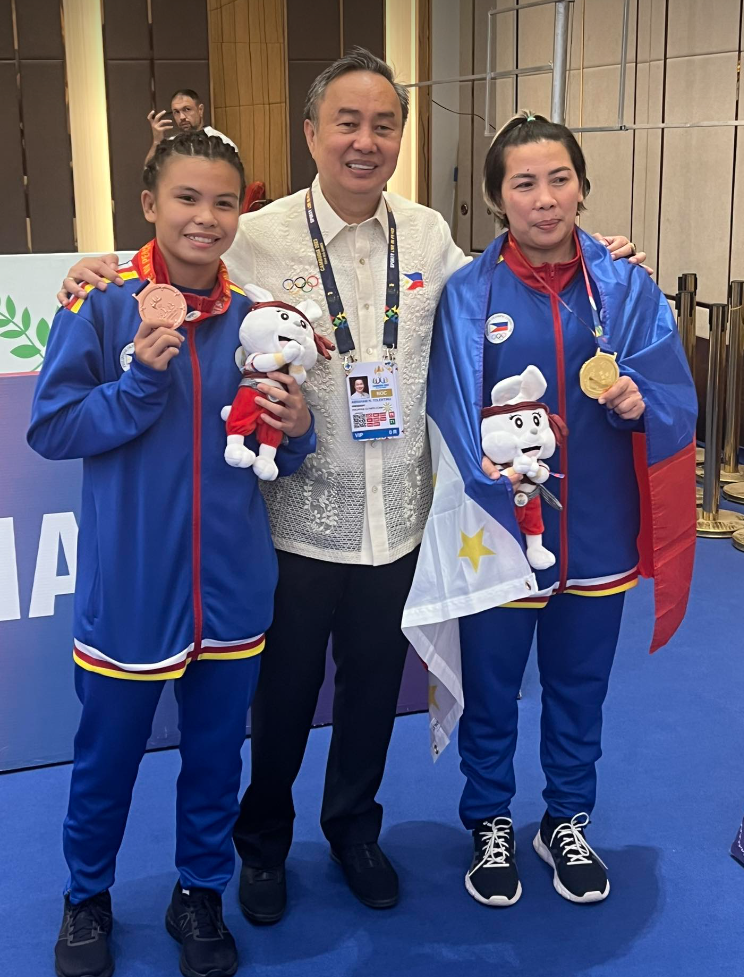Mother Christina Vergara (65 kg) and daughter Cathlyn Gee (59 kg) pose for a photo with POC President Abraham Tolentino after winning the gold and the bronze in wrestling freestyle wrestling.