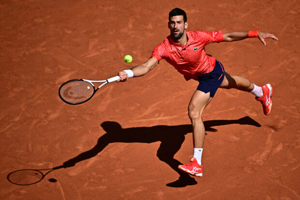 Novak Djokovic of Serbia hits back forehand against Alejandro Davidovich Fokina of Spain during their men's singles match on day six of the Roland-Garros Open tennis tournament at Court Philippe-Chatrier in Paris on June 2, 2023 (Photo by JULIEN DE ROSA / AFP )