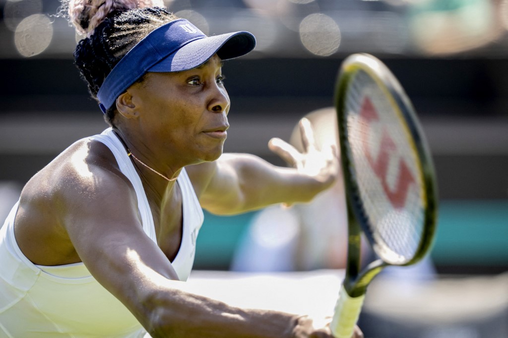 US Venus Williams attempts to return the ball to Switzerland's Celine Naef during their women's singles match on day two of the Libema Open tennis tournament in Rosmalen on June 13, 2023