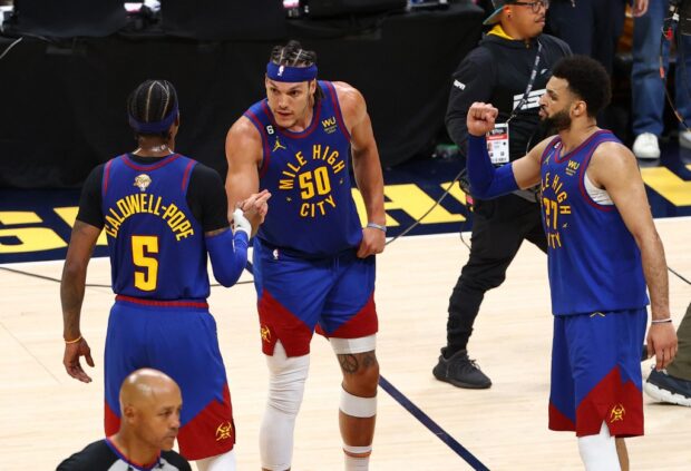  Aaron Gordon #50, Jamal Murray #27, and Kentavious Caldwell-Pope #5 of the Denver Nuggets react after a 104-93 victory against the Miami Heat in Game One of the 2023 NBA Finals at Ball Arena on June 01, 2023 in Denver, Colorado.