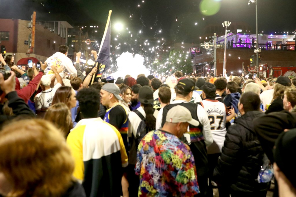 Denver Nuggets fans celebrate in downtown Denver after the end of Game Five of the 2023 NBA Finals at Ball Arena on June 12, 2023 in Denver, Colorado.