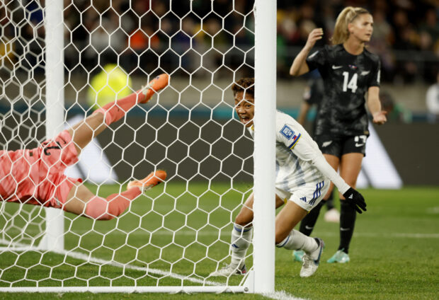Filipina Sarina Bolden eliminates New Zealand goalkeeper Victoria Esson with a powerful header.  —REUTERS