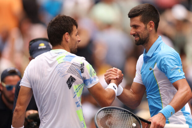 Novak Djokovic shakes hands with Spain's Bernabe Zapata Miralles