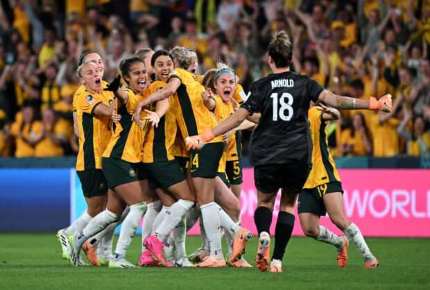 Australia players celebrate a tense quarterfinal victory over France, and a whole nation celebrated with them. —REUTERS