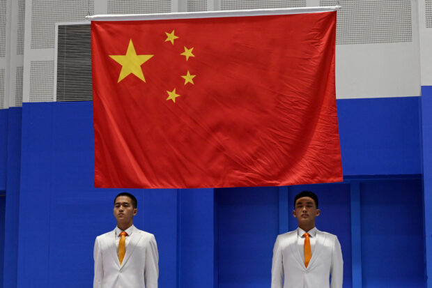 China's national flag is seen during the medal ceremony for the women's 10m air rifle shooting event during the 2022 Asian Games in Hangzhou in China's eastern Zhejiang province on September 24, 2023.
