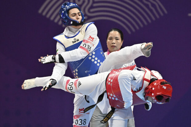 Iran's Anahita Tavakoli (L) and the Philippines’ Kirstie Alora (R) compete in the women's +67KG round of 16 event during the Hangzhou 2022 Asian Games in Hangzhou