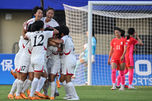North Korea's players celebrate a goal in the women's football quarter-final match between South Korea and North Korea during the Hangzhou 2022 Asian Games