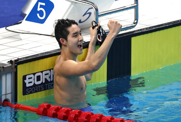 South Korea's Kim Woomin reacts after winning the Men's 800m Freestyle Fast Heat