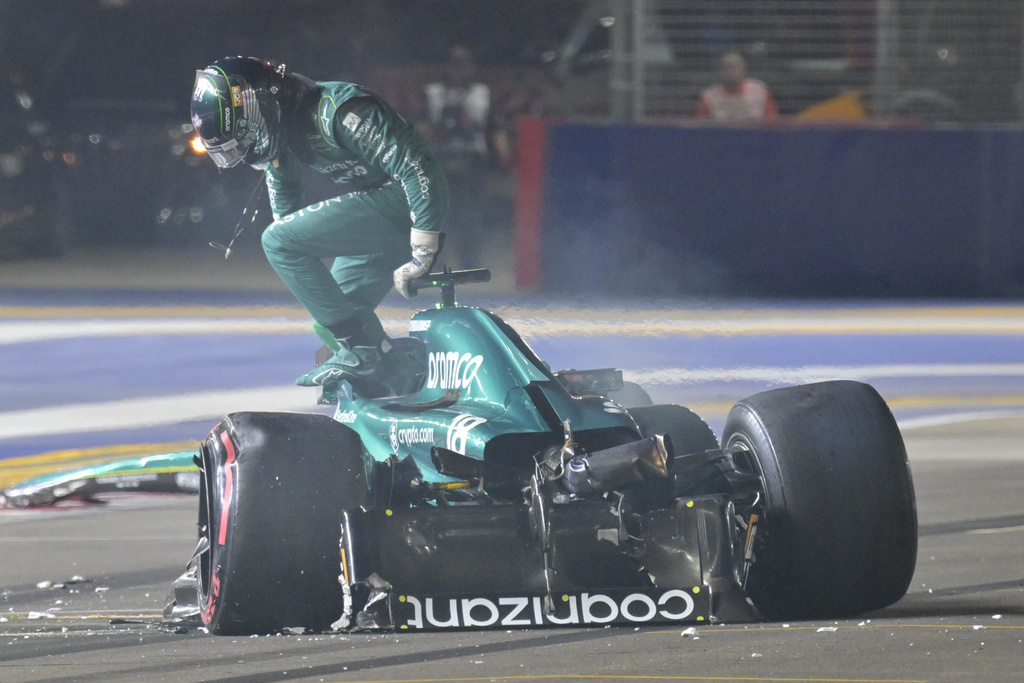 Aston Martin driver Lance Stroll of Canada goes out from his car after a crash during the qualifying session of the Singapore Formula One Grand Prix
