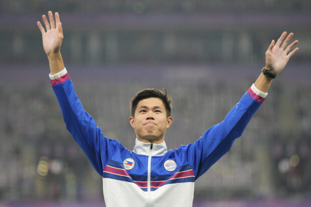Gold medalist Philippines' Ernest John Obiena celebrates on the podium during the victory ceremony for the men's pole vault at the 19th Asian Games in Hangzhou, China, 
