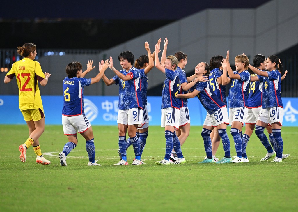 Japan's players celebrate their victory against China after the the women's semi-final football match between China and Japan during the 2022 Asian Games in Hangzhou in China's eastern Zhejiang province on October 3, 2023.