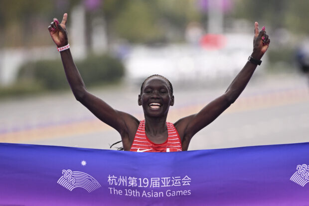 Bahrain's Eunice Chumba crosses the finish line to win the women's marathon final athletics event during the 2022 Asian Games in Hangzhou in China's eastern Zhejiang province on October 5, 2023.