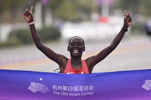 Bahrain's Eunice Chumba crosses the finish line to win the women's marathon final athletics event during the 2022 Asian Games in Hangzhou in China's eastern Zhejiang province on October 5, 2023. 