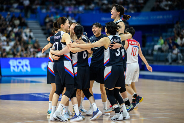 South Korean players celebrate their victory against North Korea in the women's bronze medal basketball game between North Korea and South Korea during the Hangzhou 2022 Asian Games in Hangzhou, in China's eastern Zhejiang province on October 5, 2023.