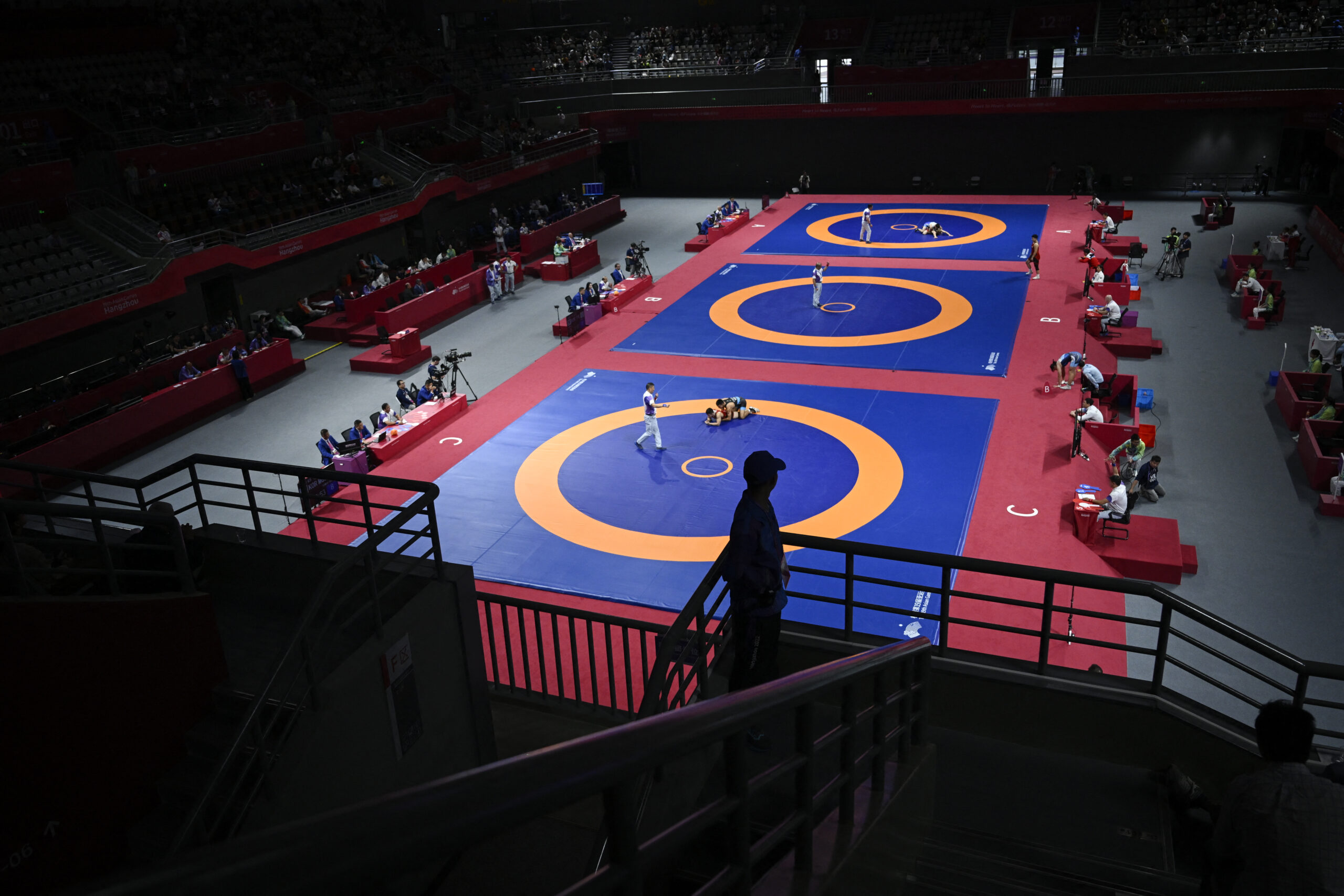 A security official keeps watch during the men’s and women's freestyle wrestling matches during the 2022 Asian Games in Hangzhou in China's eastern Zhejiang province on October 6, 2023.