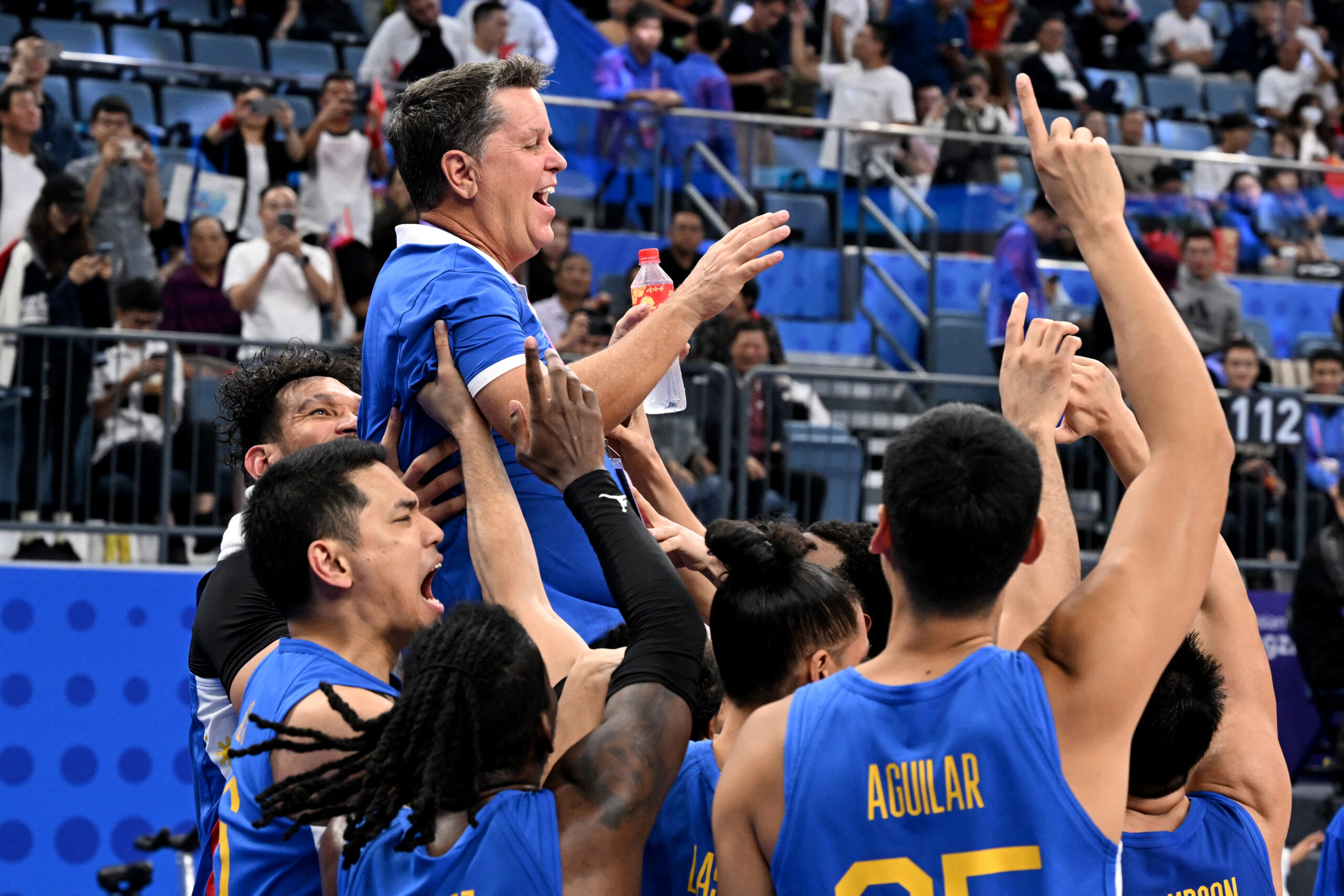 Coach Tim Cone gets the traditional celebratory ride from his players after the Philippines won the gold medal over Jordan in the men’s basketball final of the Asian Games. —AFP 