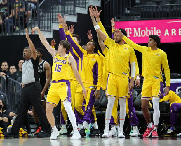  Austin Reaves #15 of the Los Angeles Lakers and his teammates on the bench follow his 3-point shot attempt against the Brooklyn Nets in the first quarter of their preseason game at T-Mobile Arena on October 09, 2023 in Las Vegas, Nevada