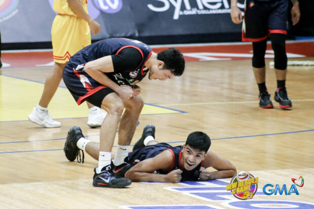 Letran's Kevin Santos hypes up Neil Guarino after a three-point bucket. –NCAA Photo