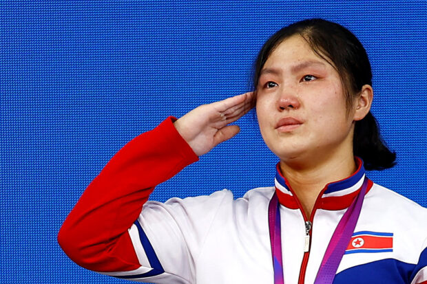 Asian Games - Hangzhou 2022 - Weightlifting - Xiaoshan Sports Centre Gymnasium, Hangzhou, China - October 2, 2023 Gold medalist, North Korea's Kim Ilgyong salutes during the medal ceremony of the Women's 59Kg Group A 
