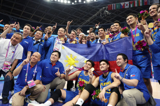Gilas Pilipinas members celebrate with their gold medals after defeating Jordan in their men's basketball gold medal at the 19th Asian Games in Hangzhou, China, Friday, Oct. 6, 2023.