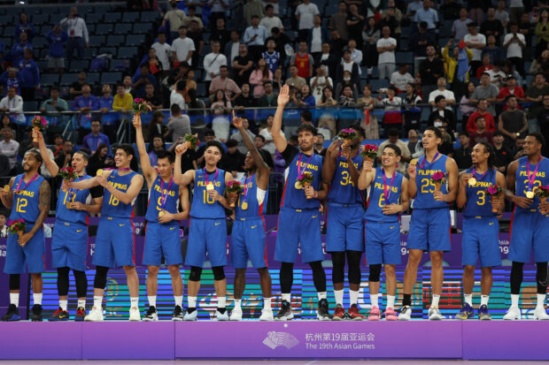 Gilas Pilipinas members celebrate with their gold medals after defeating Jordan in their men's basketball gold medal at the 19th Asian Games in Hangzhou, China, Friday, Oct. 6, 2023.