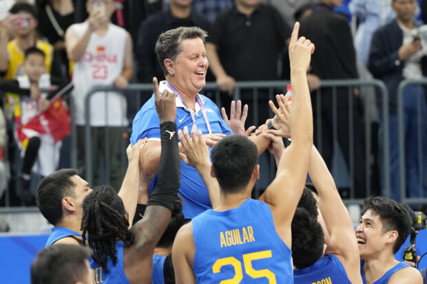 Gilas players carry their head coach Tim Cone following their win over Jordan in the men's basketball gold medal match at the 19th Asian Games in Hangzhou, China, Friday, Oct. 6, 2023.