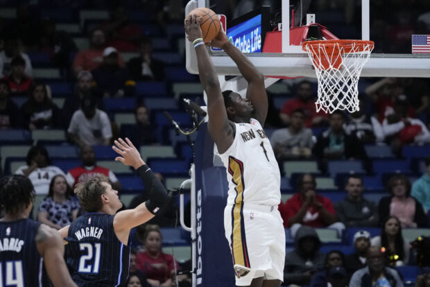 New Orleans Pelicans forward Zion Williamson (1) goes to the basket to slam dunk over Orlando Magic center Moritz Wagner