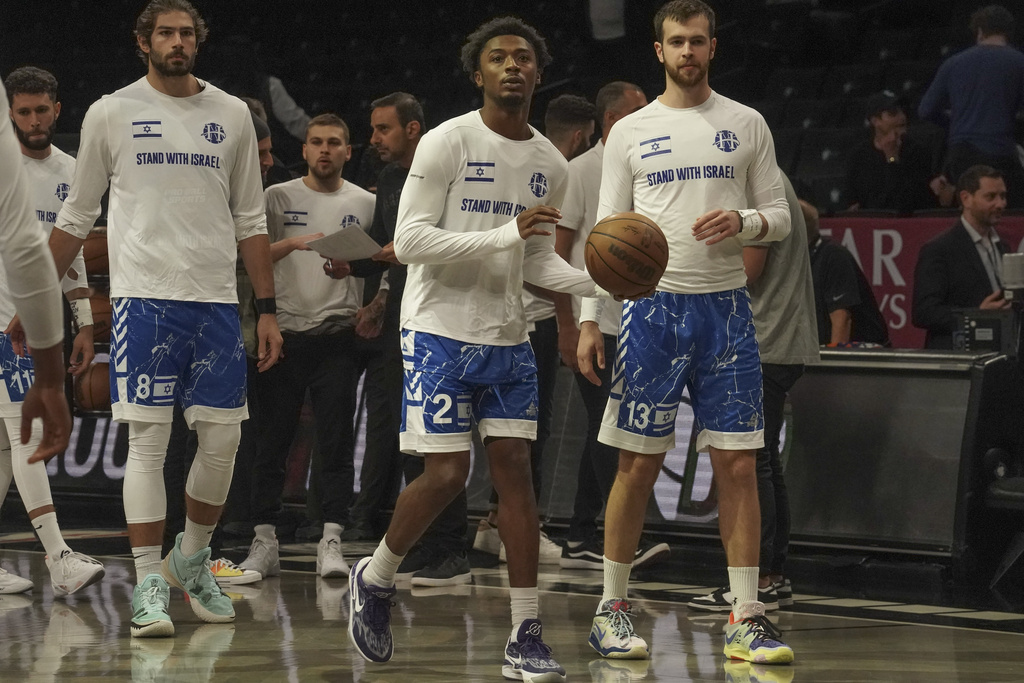 Members of Israel's Maccabi Ra'anana basketball team wear shirts in support of Israel during warmups before a preseason NBA basketball game against the Brooklyn Nets, Thursday, Oct. 12, 2023, in New York.