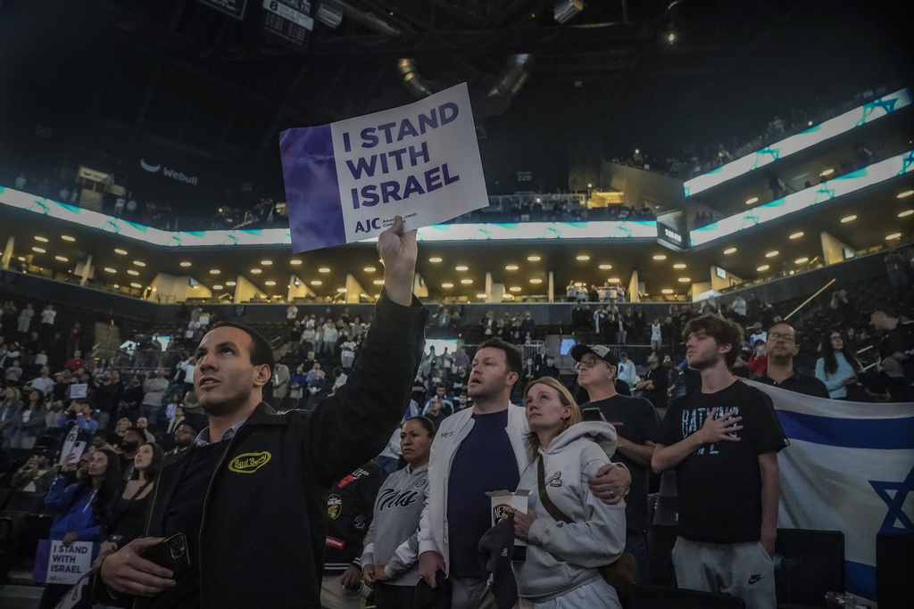 Fans show support for Israel as they stand during the national anthem before a preseason NBA basketball game between Israel's Maccabi Ra'anana and the Brooklyn Nets, Thursday, Oct. 12, 2023, in New York.