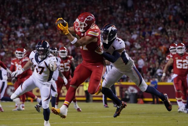 Kansas City Chiefs tight end Travis Kelce (87) makes a catch against Denver Broncos' Pat Surtain II (2) during the first half of an NFL football game, Thursday, Oct. 12, 2023, in Kansas City, Mo