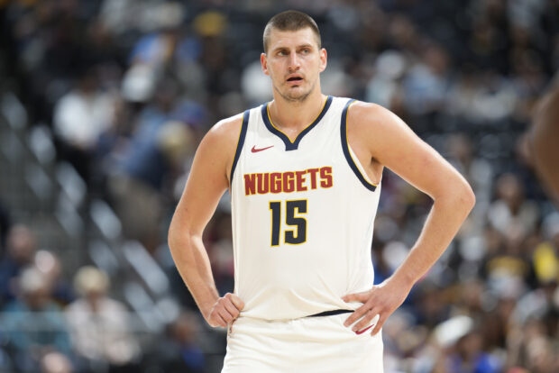 Denver Nuggets center Nikola Jokic waits for play to resume in the first half of a preseason NBA basketball game against the Chicago Bulls on Sunday, Oct. 15, 2023, in Denver.