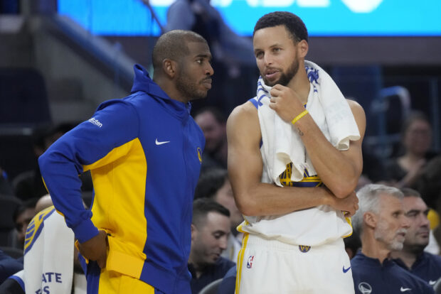 Golden State Warriors guard Chris Paul, left, talks with guard Stephen Curry during the second half of an NBA preseason basketball game against the San Antonio Spurs in San Francisco, Friday, Oct. 20, 2023. 