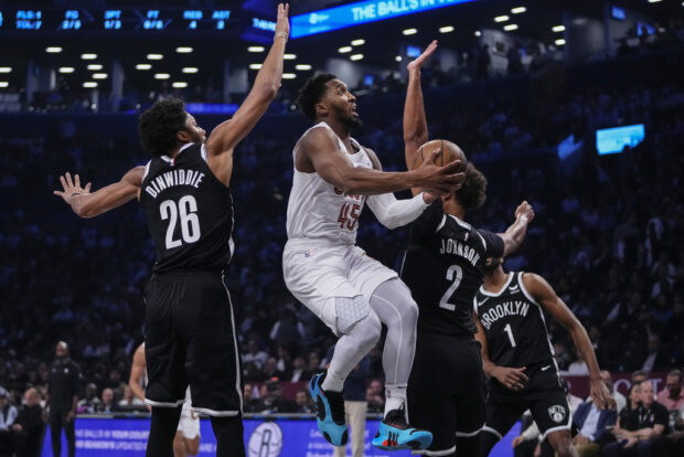 Cleveland Cavaliers' Donovan Mitchell (45) drives past Brooklyn Nets' Spencer Dinwiddie (26) during the first half of an NBA basketball game Wednesday, Oct. 25, 2023, in New York. 