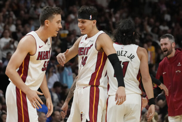 Miami Heat forward Duncan Robinson (55) and guard Tyler Herro (14) celebrate after scoring a three-point-shot 