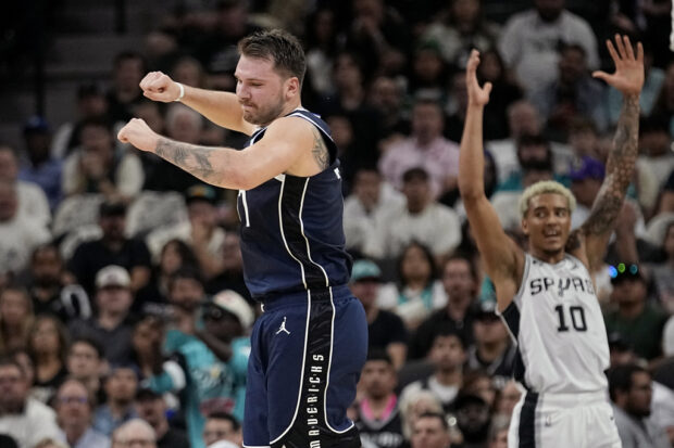 Dallas Mavericks guard Luka Doncic, left, reacts to a score against the San Antonio Spurs during the first half of an NBA basketball game in San Antonio, Wednesday, Oct. 25, 2023. 