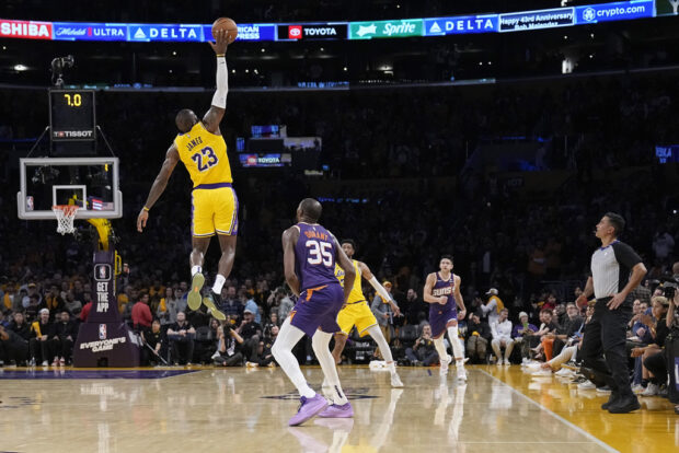 Los Angeles Lakers forward LeBron James (23) reaches for a inbound pass intended for Phoenix Suns forward Kevin Durant (35) during the second half of an NBA basketball game Thursday, Oct. 26, 2023, in Los Angeles.