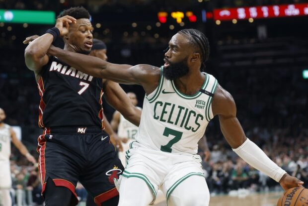 Boston Celtics' Jaylen Brown, right, keeps the ball away from Miami Heat's Kyle Lowry, left, during the second half of an NBA basketball game, Friday, Oct. 27, 2023, in Boston. 