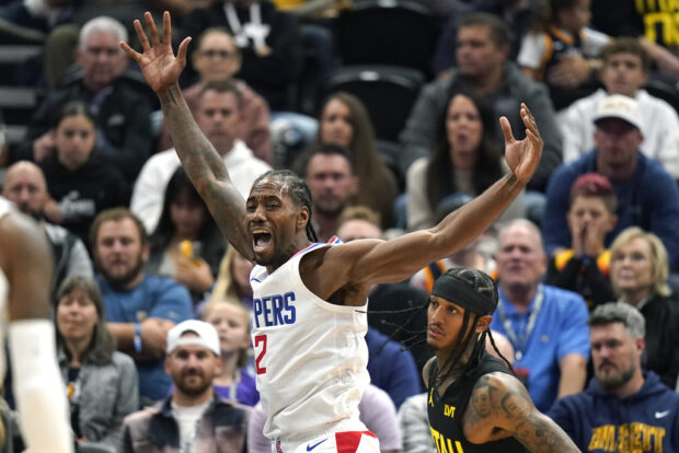 Los Angeles Clippers forward Kawhi Leonard (2) reacts as Utah Jazz guard Jordan Clarkson, right, looks on during the first half of an NBA basketball game Friday, Oct. 27, 2023, in Salt Lake City. 