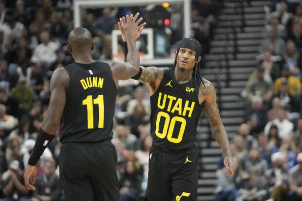 Utah Jazz's Jordan Clarkson (00) and Kris Dunn (11) celebrate during the first half of an NBA basketball game against the Los Angeles Clippers, Friday, Oct. 27, 2023, in Salt Lake City.