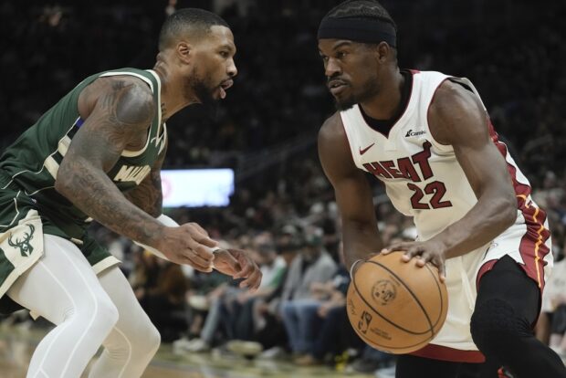 Miami Heat's Jimmy Butler tries to pass Milwaukee Bucks' Damian Lillard during the first half of an NBA basketball game on Monday, October 30, 2023,