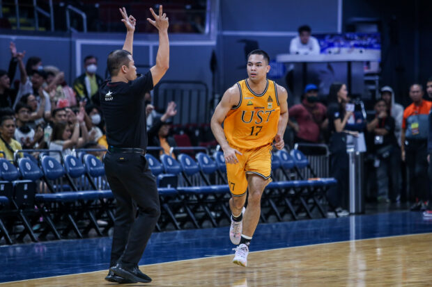 UST's Migs Pangilinan celebrates after hitting a triple in the fourth quarter against FEU.  – PHOTO UAAP