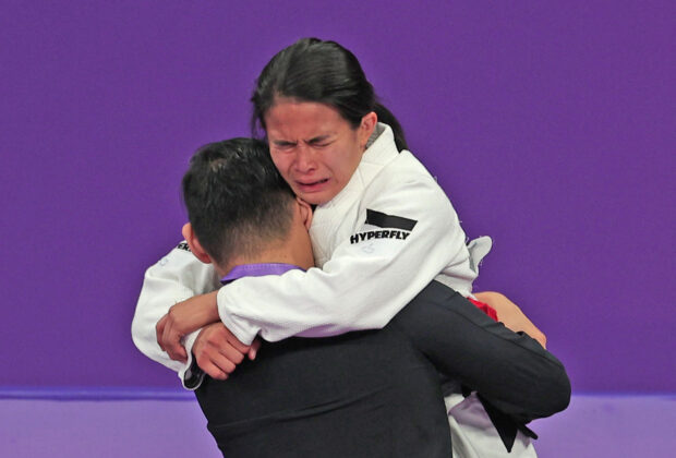 An emotional Meggie Ochoa celebrates winning gold in the Asian Games women's 48kg jiu-jitsu in Hangzhou, China. 
