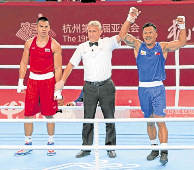 Eumir Marcial (right) celebrates his knockout win. —ASIAN GAMES POOL
