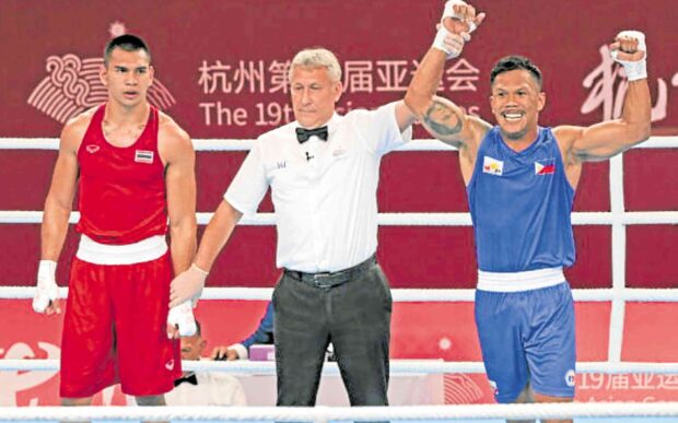 Eumir Marcial (right) celebrates his knockout win. —ASIAN GAMES POOL