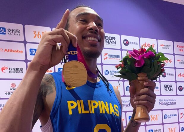 Chris Newsome holds up his gold medal after Gilas Pilipinas won the 19th Asian Games in Hangzhou, China