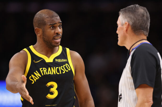  Chris Paul #3 of the Golden State Warriors reacts to referee Scott Foster #48 during the first half of the NBA game against the Phoenix Suns at Footprint Center on November 22, 2023 in Phoenix, Arizona